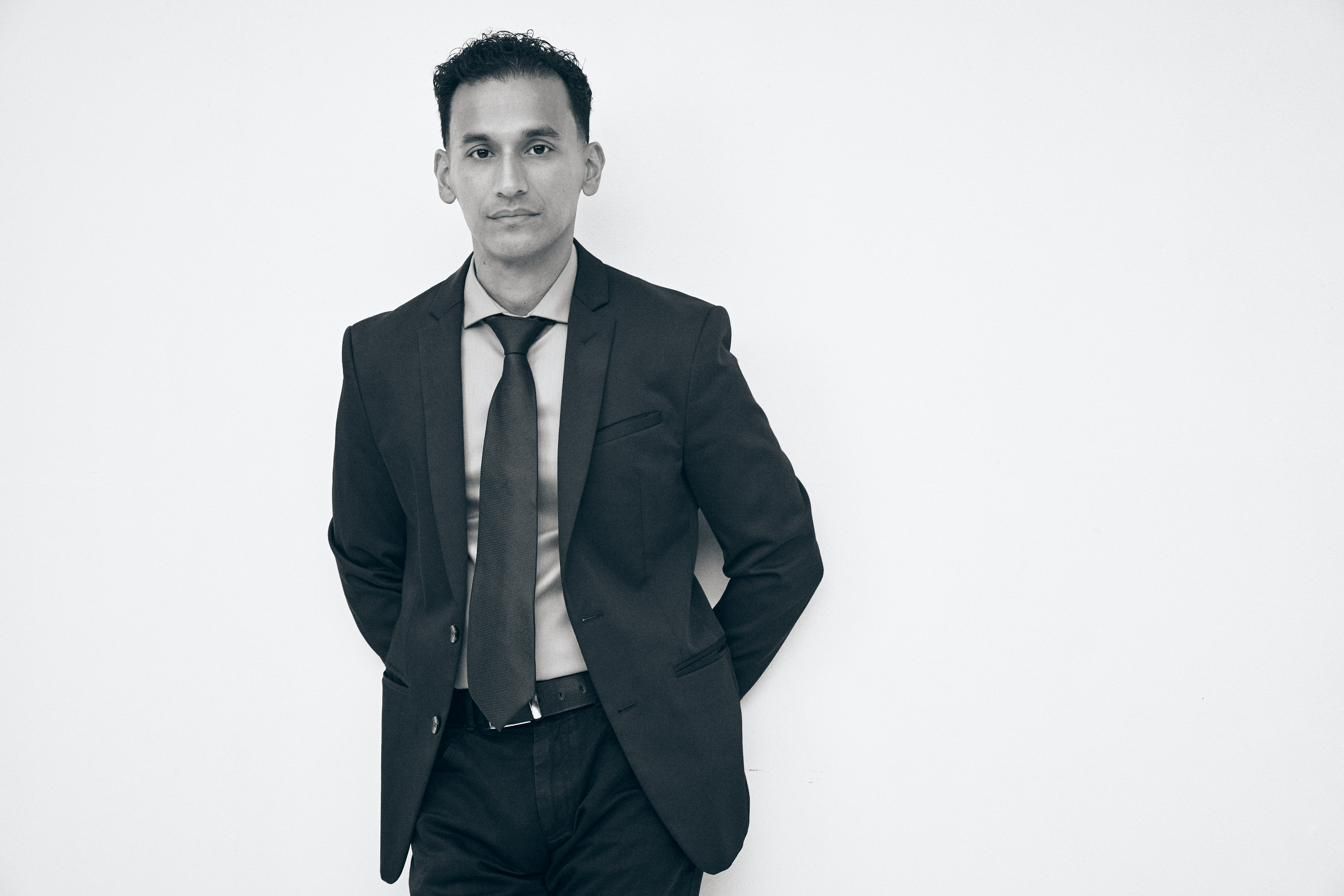 Goya Robles in a suit, black-and-white portrait