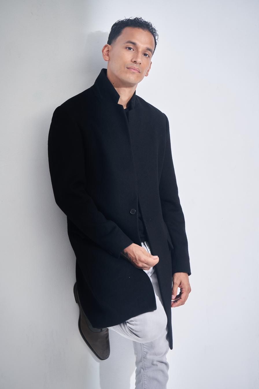 Goya Robles standing in a black coat